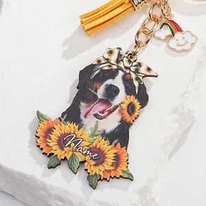Detail of custom Bernese Mountain Dog keychain with sunflower motif and yellow tassel