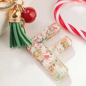 Christmas letter F resin keychain with snowman decor, green tassel, and red bell