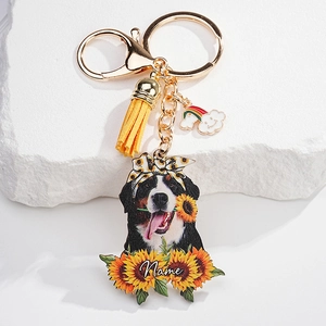 Detail of custom pet keychain with yellow tassel, rainbow charm, and dog portrait