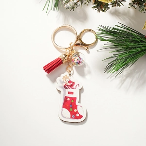 Close-up of Christmas keychain with red leather tassel and transparent sequin star ball
