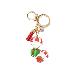 Porte-clés de Noël avec pompon rouge, anneau doré et pendentif boule à paillettes étoiles