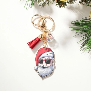 Detail of Santa Claus keychain with trendy sunglasses, red tassel and star-filled clear ball