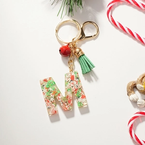 Detailed view of Christmas resin letter M keychain with snowman and festive tassel