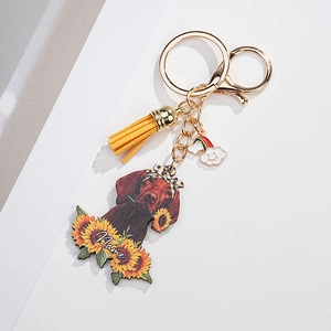 Custom dog keychain with sunflower base, yellow tassel, and personalized name detail