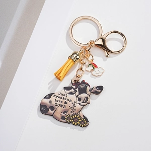 Detail of keychain with cow tag pendant yellow tassel and golden metal hardware clip