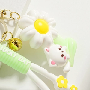Cute white cat and daisy flower keychain with Lucky Day green silicone strap and gold bell