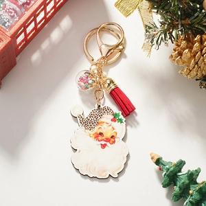Detail of Christmas Santa keychain with leopard print hat, red tassel, and star sequins ball