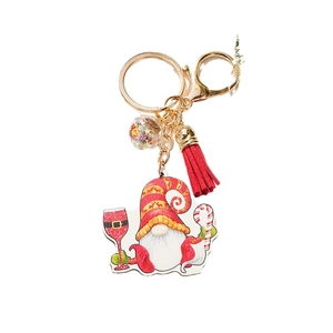 Christmas gnome wooden keychain with red tassel and sparkling star charm on white background