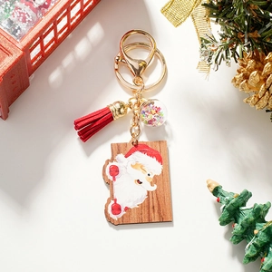 Detail of wooden Santa keychain with red tassel and sparkling star sequins