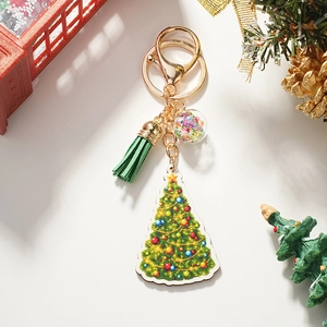 Detailed view of a festive Christmas tree keychain with green tassel and decorative charms