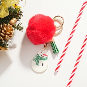 Christmas keychain with red faux fur pompom, snowman charm and green leather tassel