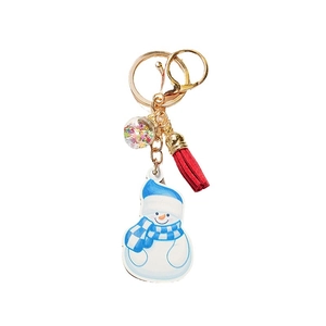 Christmas snowman keychain with blue hat and red tassel on a white background