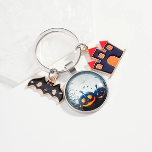 Halloween keychain with pumpkin glass cabochon, black bat and haunted castle charms
