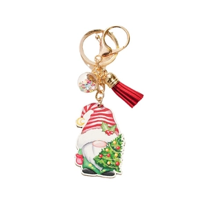 Christmas gnome wooden keychain with red tassel, sequin ball, and golden ring on white background