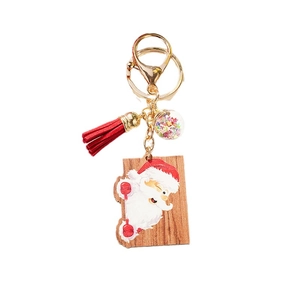 Cute winking Santa wooden keychain with vibrant red leather tassel and colorful star sequins