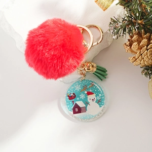 Detailed view of Christmas snowman acrylic charm with a red pompom and golden bell