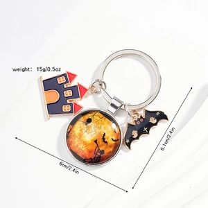 Detail of Halloween keychain with castle, bat charms and Happy Halloween emblem