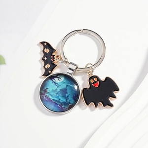 Detail of Halloween keychain with bat, ghost, and glowing night castle glass pendant