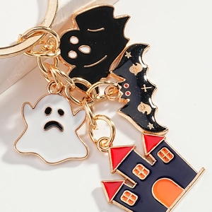Halloween keychain with ghost, bat and haunted castle charms in gold enamel finish
