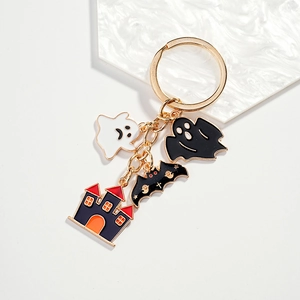 Halloween keychain set with ghost, bat, and castle charms in gold-plated enamel finish