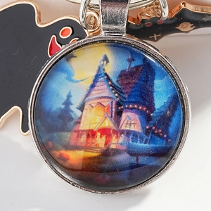 Halloween keychain featuring blue witch castle and full moon in round glass pendant