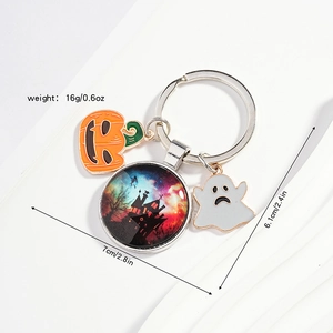Macro detail of Halloween keychain with pumpkin, ghost, and castle glass pendant charms