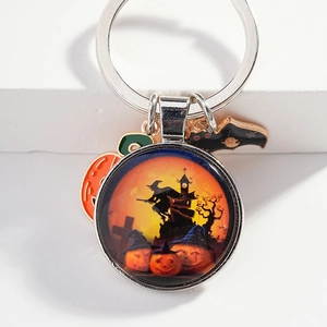 Halloween keychain with glass pendant featuring a witch and pumpkin metal charms