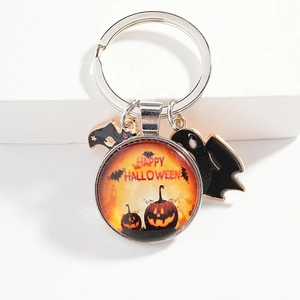 Halloween keychain with pumpkin glass pendant, metal ghost and bat charms on white background