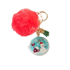 Christmas snowman keychain with a large red pompom, green tassel, and golden hardware