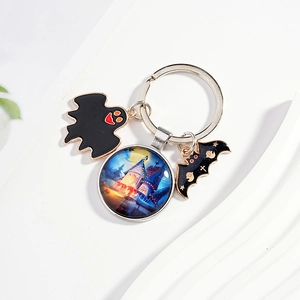Halloween keychain with blue witch castle glass dome, black ghost and bat charms on metal ring
