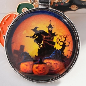 Halloween keychain with glass pendant featuring witch, pumpkin and bat charms