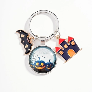 Halloween keychain with bat, glowing pumpkin glass charm, and spooky castle charms
