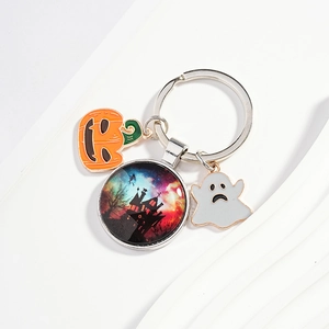 Halloween keychain with pumpkin, ghost, and witch castle glass pendant on white wave background