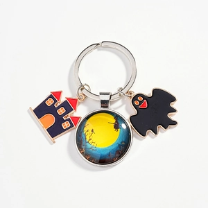 Halloween keychain with moon witch glass pendant and spooky castle charms on metal ring