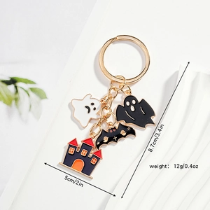 Detail showing dimensions of Halloween ghost and castle keychain with gold metal finish