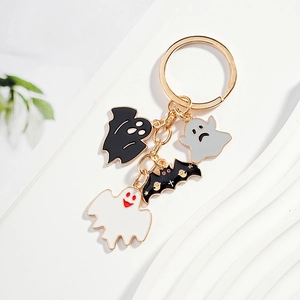 Halloween keychain with colorful enamel ghosts and black bat on a gold ring