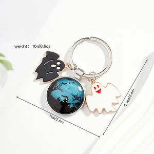 Close-up of Halloween keychain with blue castle glass ball and ghost charms