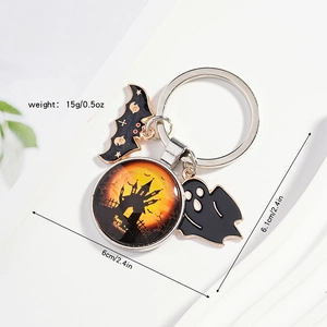Macro shot of Halloween keychain with bat, ghost, and spooky castle charms on white background