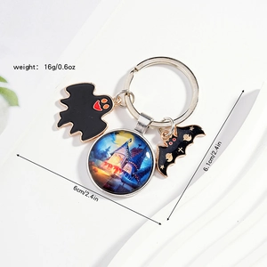 Detail view of Halloween keychain featuring blue castle glass gem and ghost bat charms