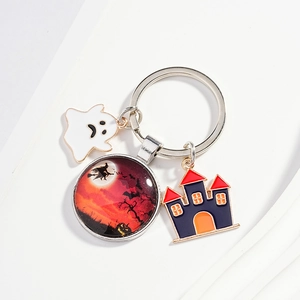 Halloween keychain with ghost, castle and witch on broom pendants on a white background