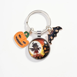Halloween keychain with pumpkin charm, scarecrow castle glass bead, and black bat pendant