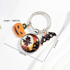 Detailed view of Halloween keychain with pumpkin, bat charms and scarecrow glass dome