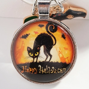Halloween keychain with round glass pendant featuring black cat, bat and moon designs