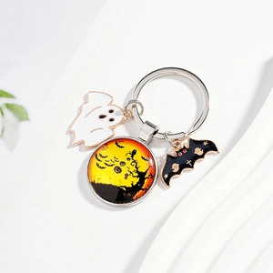 Halloween keychain with ghost pendants and bat charms on minimalist white stand