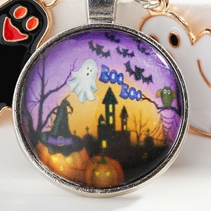 Halloween keychain with purple witch castle and ghost pattern on a glass dome pendant