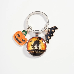 Halloween keychain with pumpkin, bat charms and cat glass pendant on white background