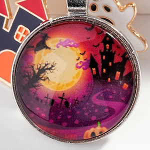 Halloween metal keychain featuring a glass pendant with witch, bats, and castle illustration
