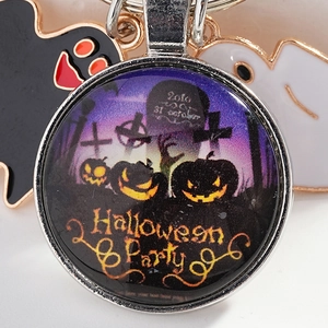 Halloween keychain with pumpkin glass dome and ghost charms on silver metal ring