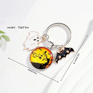 Detailed Halloween keychain with white ghost, crescent moon pumpkin, and black bat charms