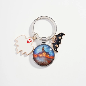 Halloween keychain featuring blue ghost house, white enamel ghost, and black bat charms